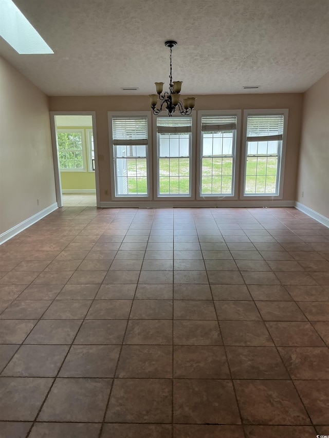 983 Nottingham Lakes Rd, Conway, SC 29526 - unfurnished dining area featuring a chandelier, tile patterned flooring, a textured ceiling, and a skylight