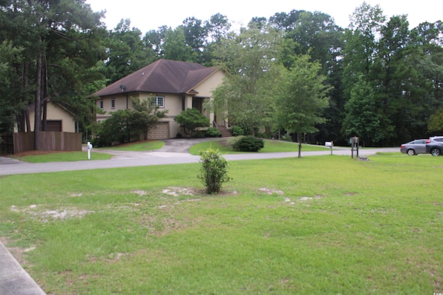 983 Nottingham Lakes Rd, Conway, SC 29526 - ranch-style home featuring a front lawn, driveway, stucco siding, and a garage
