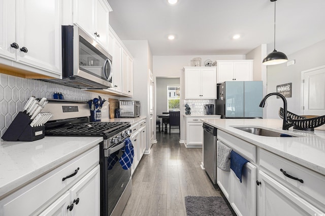 312 Cattle Drive Cir, Myrtle Beach, SC 29588 - kitchen featuring stainless steel appliances, white cabinets, backsplash, hanging light fixtures, and recessed lighting