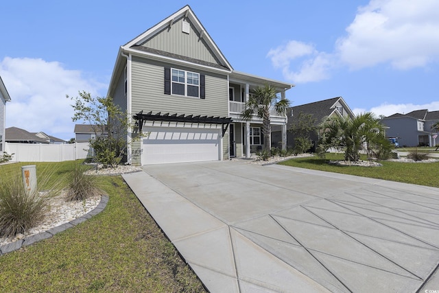 312 Cattle Drive Cir, Myrtle Beach, SC 29588 - view of front of house featuring board and batten siding, driveway, an attached garage, a balcony, and a residential view