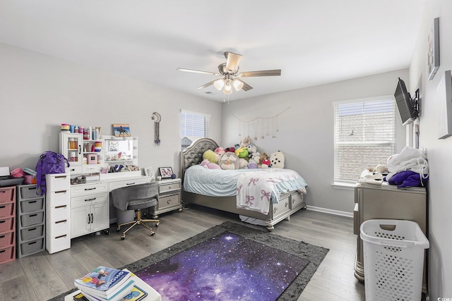 312 Cattle Drive Cir, Myrtle Beach, SC 29588 - bedroom with multiple windows, dark wood-style flooring, and a ceiling fan