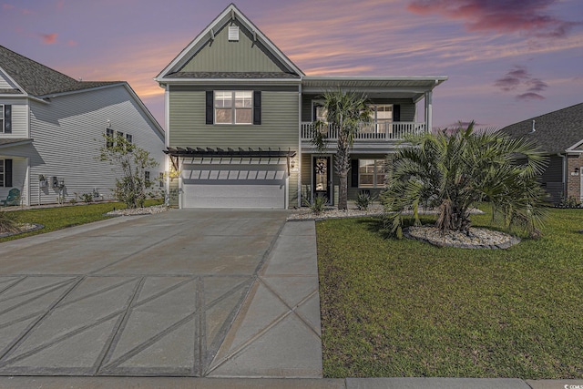 312 Cattle Drive Cir, Myrtle Beach, SC 29588 - view of front of home with driveway, a balcony, an attached garage, a front yard, and board and batten siding