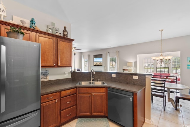 569 Ramblewood Cir, Little River, SC 29566 - kitchen with freestanding refrigerator, dishwasher, a peninsula, light tile patterned flooring, and dark countertops