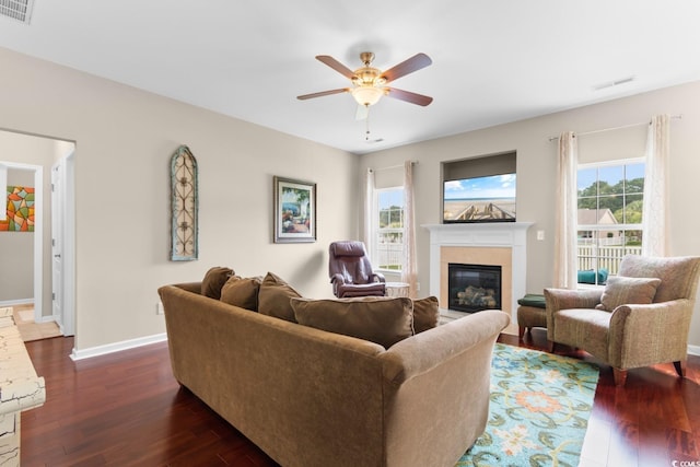 569 Ramblewood Cir, Little River, SC 29566 - living area featuring dark wood-style floors, a glass covered fireplace, and a ceiling fan