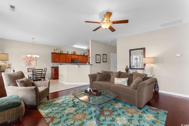 569 Ramblewood Cir, Little River, SC 29566 - living room with wood finished floors, ceiling fan, and a chandelier