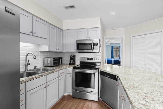 1101 Possum Trot Rd Unit A301, North Myrtle Beach, SC 29582 - kitchen featuring appliances with stainless steel finishes, wood finished floors, light countertops, tasteful backsplash, and recessed lighting