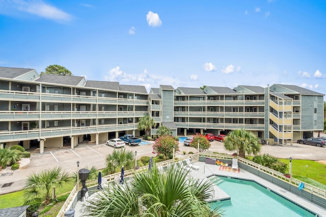 1101 Possum Trot Rd Unit A301, North Myrtle Beach, SC 29582 - view of apartment building / complex with uncovered parking and a community pool