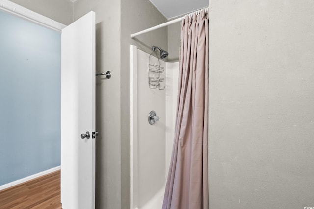 1101 Possum Trot Rd Unit A301, North Myrtle Beach, SC 29582 - full bathroom featuring wood finished floors and a shower with curtain