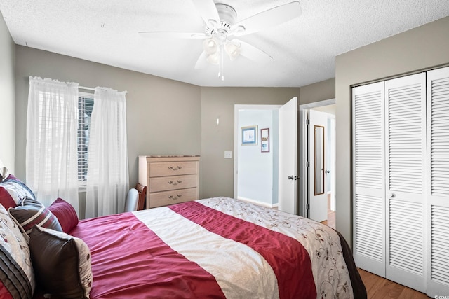 1101 Possum Trot Rd Unit A301, North Myrtle Beach, SC 29582 - bedroom with wood finished floors, a closet, a ceiling fan, and a textured ceiling