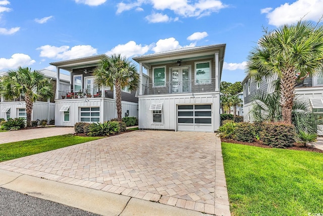 202 Clam Digger Loop, Pawleys Island, SC 29585 - view of front facade featuring board and batten siding, ceiling fan, decorative driveway, and a front yard