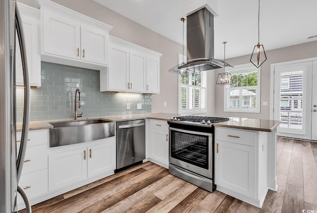 202 Clam Digger Loop, Pawleys Island, SC 29585 - kitchen with stainless steel appliances, island exhaust hood, a peninsula, and light wood finished floors