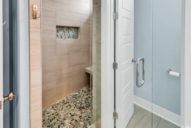 202 Clam Digger Loop, Pawleys Island, SC 29585 - bathroom featuring a tile shower and tile patterned flooring
