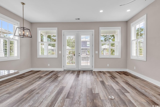 202 Clam Digger Loop, Pawleys Island, SC 29585 - unfurnished dining area featuring wood finished floors, french doors, plenty of natural light, a chandelier, and recessed lighting