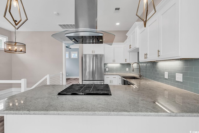 202 Clam Digger Loop, Pawleys Island, SC 29585 - kitchen with stainless steel fridge, tasteful backsplash, light stone counters, and white cabinets
