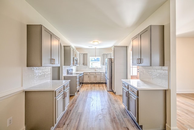 4000 Bayfield Loop, Murrells Inlet, SC 29576 - kitchen featuring appliances with stainless steel finishes, gray cabinets, light wood-style flooring, and light countertops