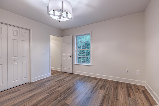 4000 Bayfield Loop, Murrells Inlet, SC 29576 - unfurnished bedroom with wood finished floors, a closet, and a chandelier
