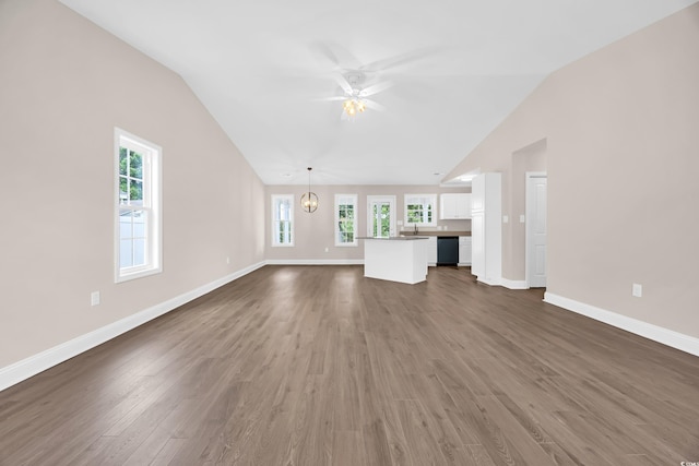 9655 Kings Grant Dr, Murrells Inlet, SC 29576 - unfurnished living room featuring lofted ceiling, plenty of natural light, dark wood-style flooring, and a ceiling fan