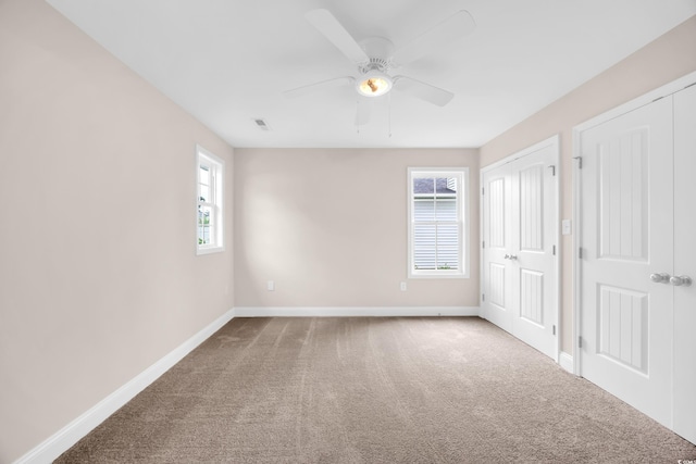 9655 Kings Grant Dr, Murrells Inlet, SC 29576 - unfurnished bedroom featuring carpet floors, a ceiling fan, and two closets