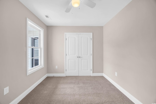 9655 Kings Grant Dr, Murrells Inlet, SC 29576 - unfurnished bedroom with carpet, a closet, and a ceiling fan