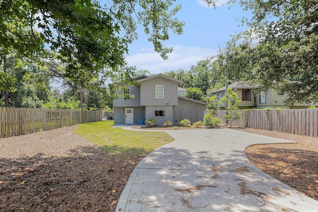 1005 28th Ave S, North Myrtle Beach, SC 29582 - rear view of property with driveway and a fenced backyard
