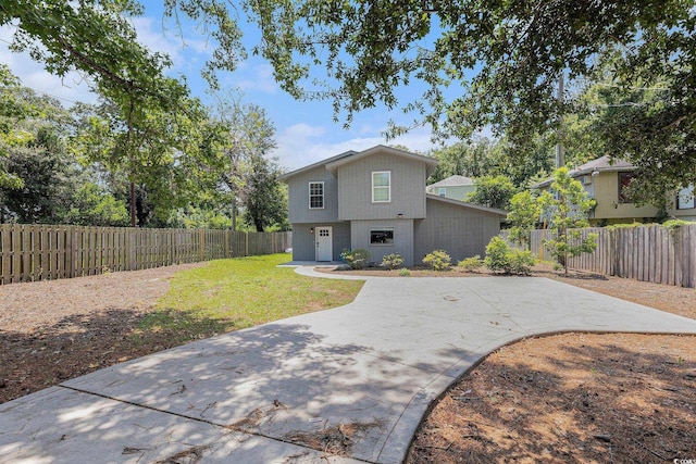 1005 28th Ave S, North Myrtle Beach, SC 29582 - view of front of house featuring a patio area and a fenced backyard