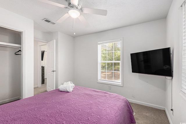 1005 28th Ave S, North Myrtle Beach, SC 29582 - bedroom with light carpet, a textured ceiling, and ceiling fan