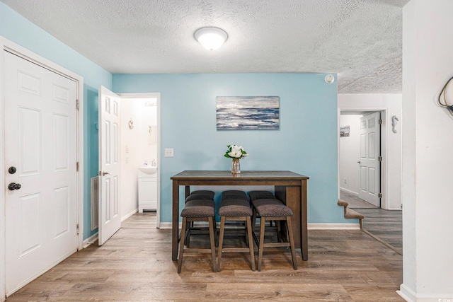 1005 28th Ave S, North Myrtle Beach, SC 29582 - dining space with wood finished floors and a textured ceiling