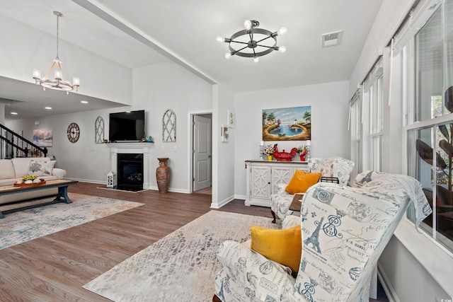 3909 On Deck Cir, Little River, SC 29566 - living room with a chandelier, wood finished floors, stairway, and a fireplace with flush hearth