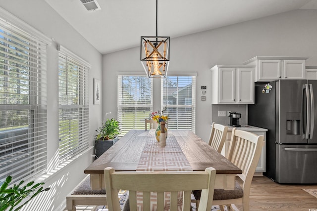 3909 On Deck Cir, Little River, SC 29566 - dining area with vaulted ceiling, light wood-style floors, and a chandelier