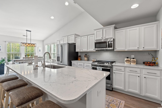 3909 On Deck Cir, Little River, SC 29566 - kitchen with stainless steel appliances, white cabinetry, a breakfast bar area, plenty of natural light, and recessed lighting