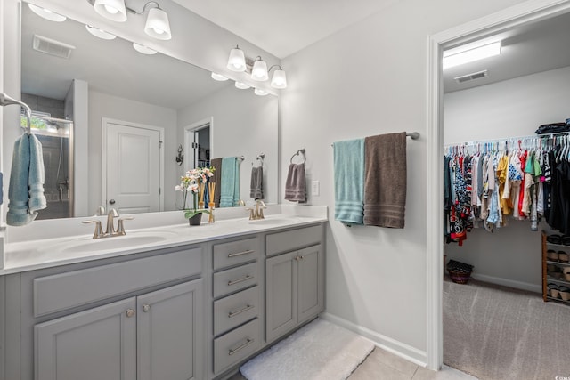 3909 On Deck Cir, Little River, SC 29566 - bathroom with double vanity, a spacious closet, tile patterned flooring, and a shower stall