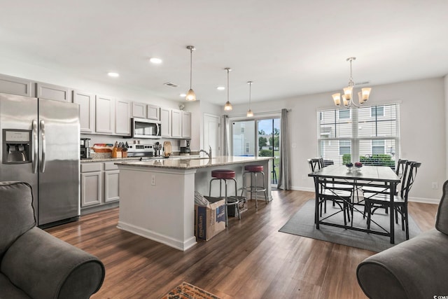 1117 Fairway Ln Unit 1117, Conway, SC 29526 - kitchen featuring appliances with stainless steel finishes, recessed lighting, a chandelier, a breakfast bar, and dark wood-style floors