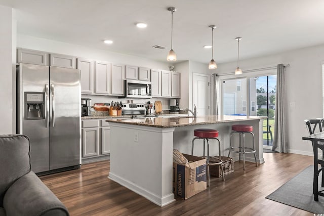 1117 Fairway Ln Unit 1117, Conway, SC 29526 - kitchen featuring stainless steel appliances, recessed lighting, dark wood-style flooring, a breakfast bar, and a kitchen island with sink