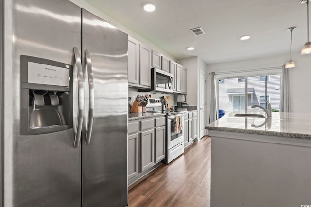 1117 Fairway Ln Unit 1117, Conway, SC 29526 - kitchen with stainless steel appliances, light stone counters, dark wood-style flooring, recessed lighting, and gray cabinetry