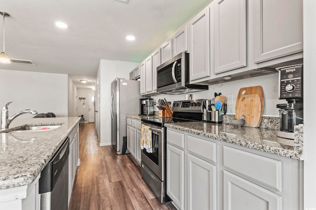 1117 Fairway Ln Unit 1117, Conway, SC 29526 - kitchen with stainless steel appliances, wood finished floors, light stone counters, pendant lighting, and recessed lighting