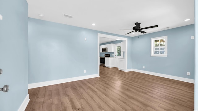1553 Watson Ave, Little River, SC 29566 - unfurnished living room with ceiling fan, wood finished floors, and recessed lighting