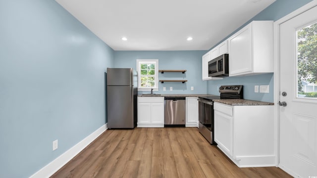 1553 Watson Ave, Little River, SC 29566 - kitchen featuring appliances with stainless steel finishes, light wood finished floors, open shelves, white cabinets, and recessed lighting