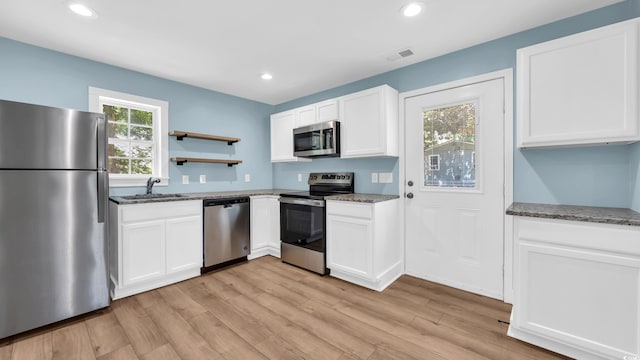 1553 Watson Ave, Little River, SC 29566 - kitchen featuring appliances with stainless steel finishes, dark stone countertops, light wood-type flooring, and recessed lighting