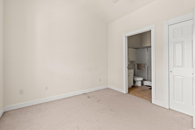 110 S Shore Blvd Unit 303, Longs, SC 29568 - unfurnished bedroom featuring carpet, vaulted ceiling, and ensuite bathroom