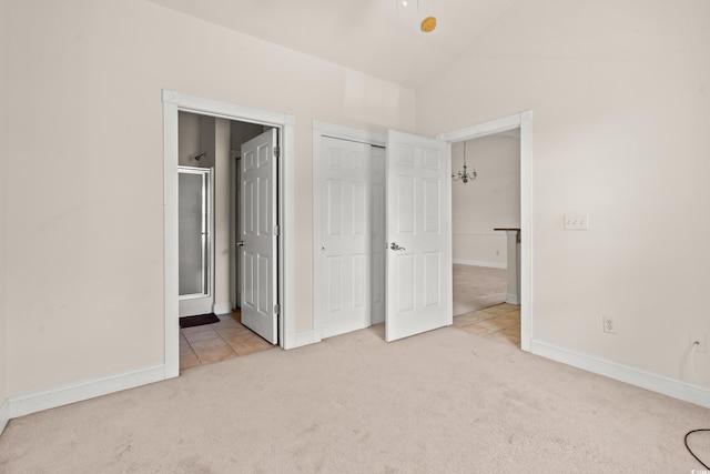110 S Shore Blvd Unit 303, Longs, SC 29568 - unfurnished bedroom featuring carpet flooring, vaulted ceiling, ensuite bathroom, and a closet