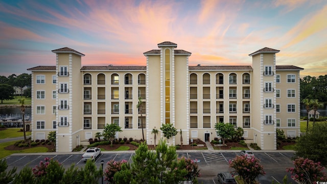 265 Venice Way Unit 1-404, Myrtle Beach, SC 29577 - property at dusk featuring uncovered parking