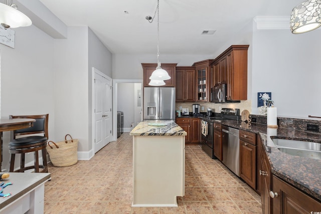 265 Venice Way Unit 1-404, Myrtle Beach, SC 29577 - kitchen featuring stainless steel appliances, pendant lighting, glass insert cabinets, a kitchen island, and dark stone countertops