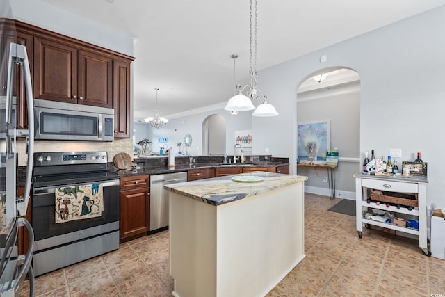 265 Venice Way Unit 1-404, Myrtle Beach, SC 29577 - kitchen featuring stainless steel appliances, arched walkways, crown molding, dark stone countertops, and pendant lighting
