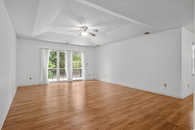 1415 Fox Hollow Way N, Myrtle Beach, SC 29582 - spare room featuring a tray ceiling, a ceiling fan, and light wood-style flooring