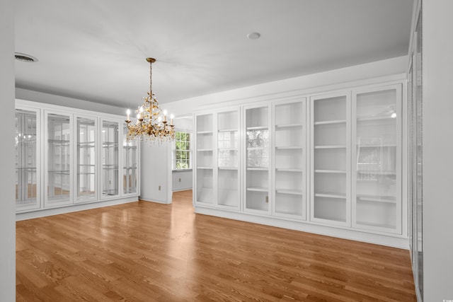 1415 Fox Hollow Way N, Myrtle Beach, SC 29582 - unfurnished dining area with a chandelier and wood finished floors