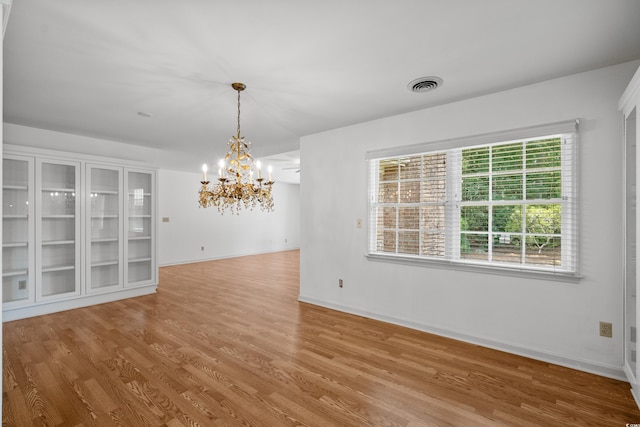 1415 Fox Hollow Way N, Myrtle Beach, SC 29582 - empty room with a chandelier and wood finished floors