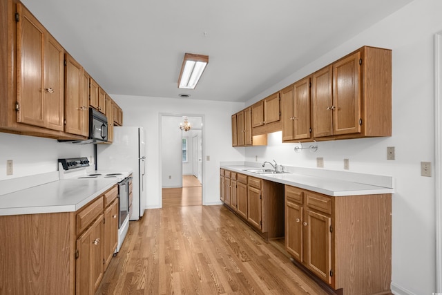1415 Fox Hollow Way N, Myrtle Beach, SC 29582 - kitchen featuring electric stove, black microwave, light wood-style floors, and light countertops