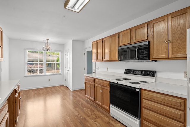 1415 Fox Hollow Way N, Myrtle Beach, SC 29582 - kitchen featuring white range with electric cooktop, black microwave, light wood-style flooring, light countertops, and a chandelier