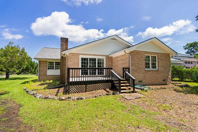 1415 Fox Hollow Way N, Myrtle Beach, SC 29582 - back of property with brick siding, a deck, a yard, and a chimney