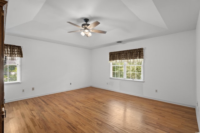 1415 Fox Hollow Way N, Myrtle Beach, SC 29582 - empty room with a raised ceiling, a ceiling fan, and light wood-style flooring